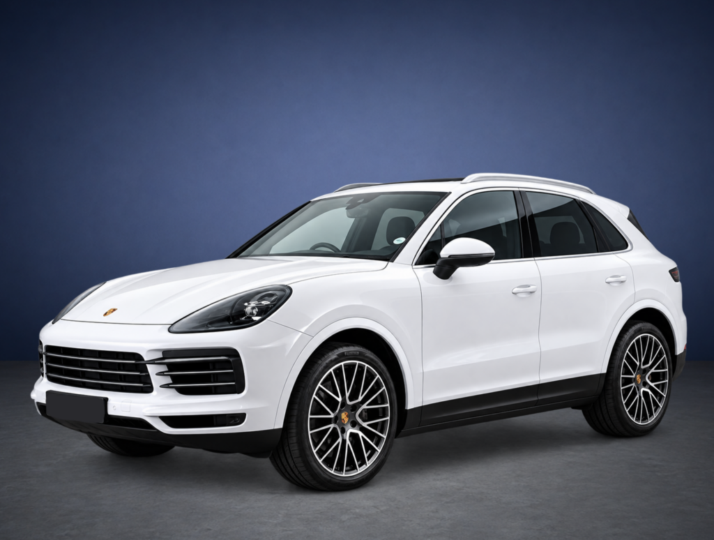 White Porsche SUV shown from the front-right side against a dark blue studio backdrop, partial view of the front grille and wheel.
